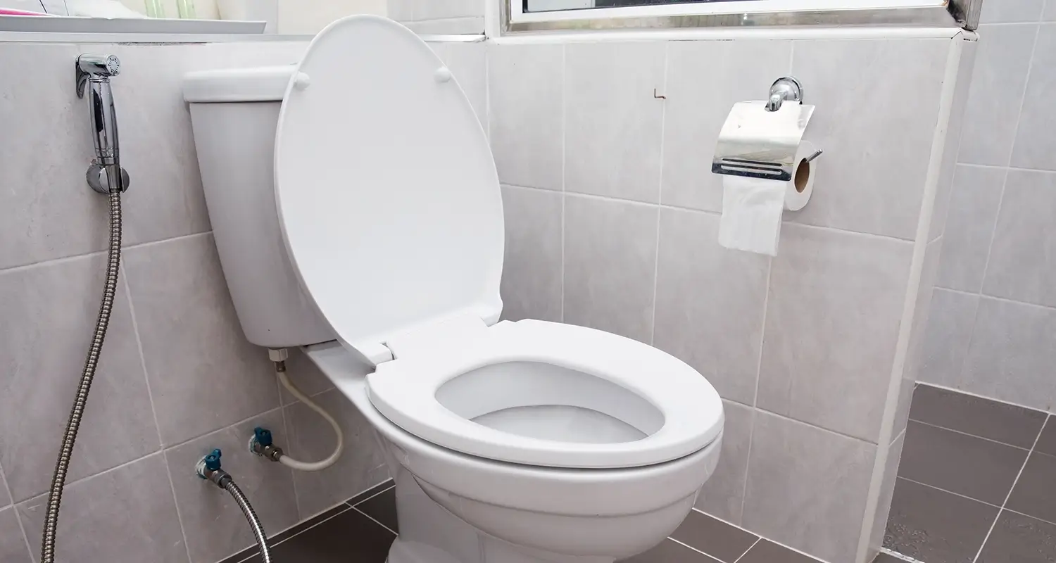 A toilet in a clean bathroom.