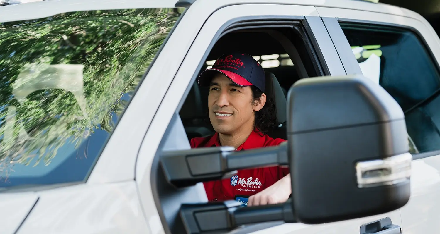 Mr Rooter Plumber driving a work van.
