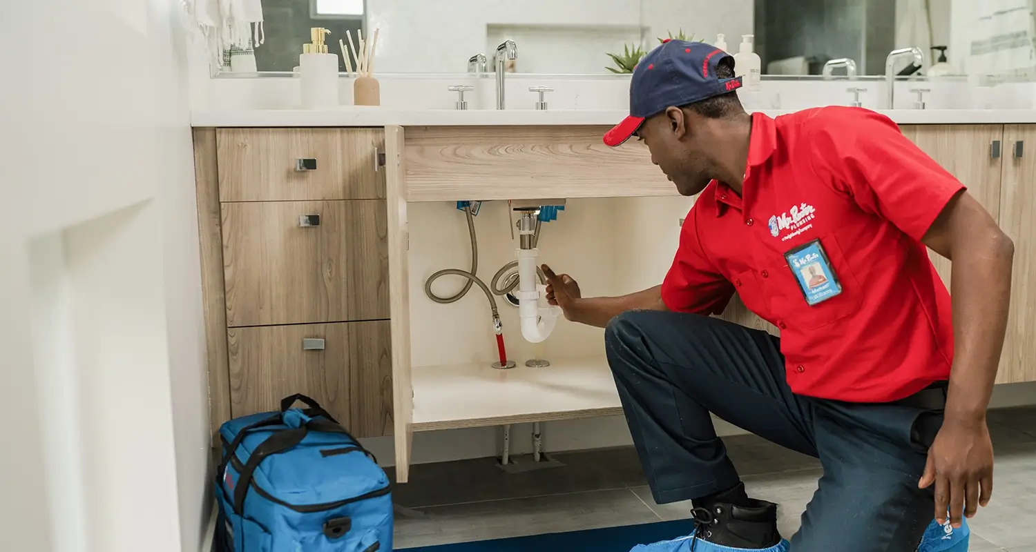 Bathroom sink being repaired by a Mr Rooter Plumber.